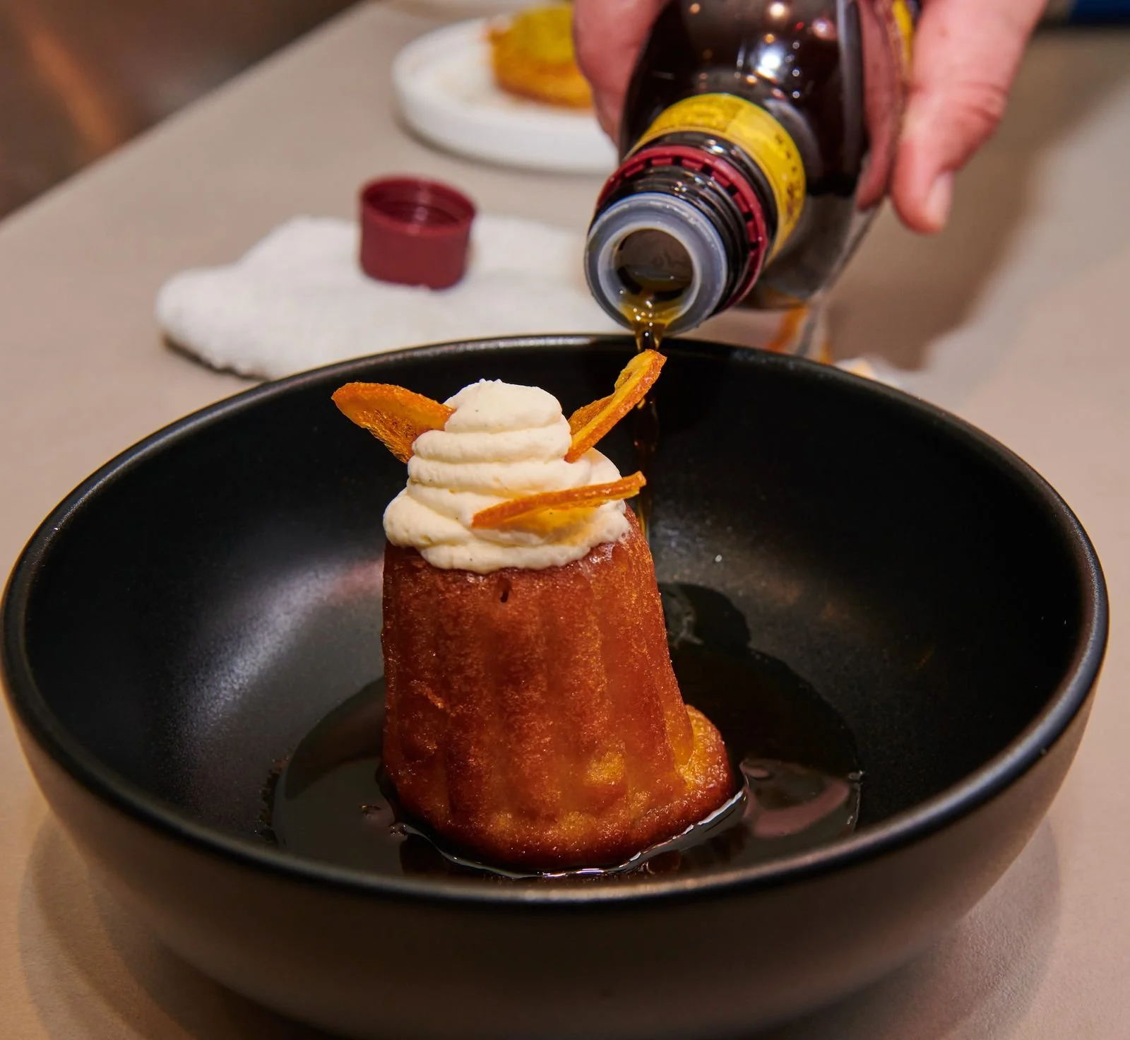 Sauce poured over a plated dessert at a CIA at Copia event, food event photography