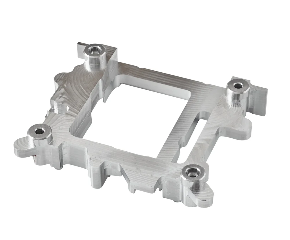 Machined aluminum bracket on white, industrial parts photography
