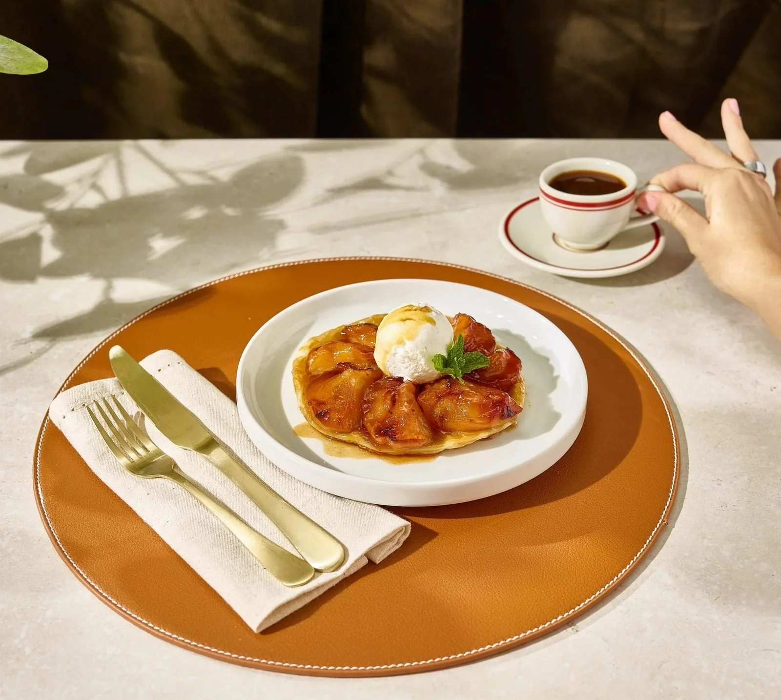 Food styling: plated breakfast pastry with cream and coffee