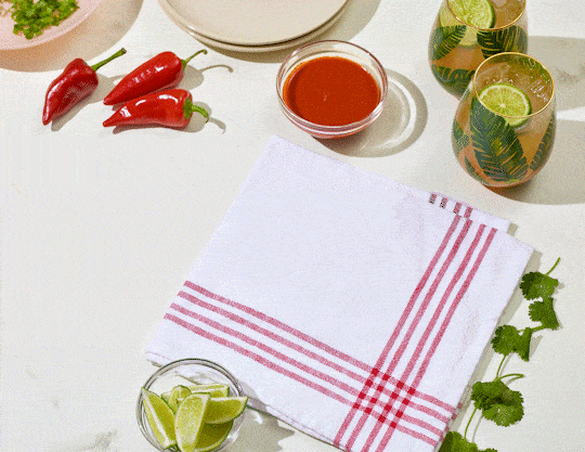 Baked enchiladas with salsa, peppers and drinks, food stop motion