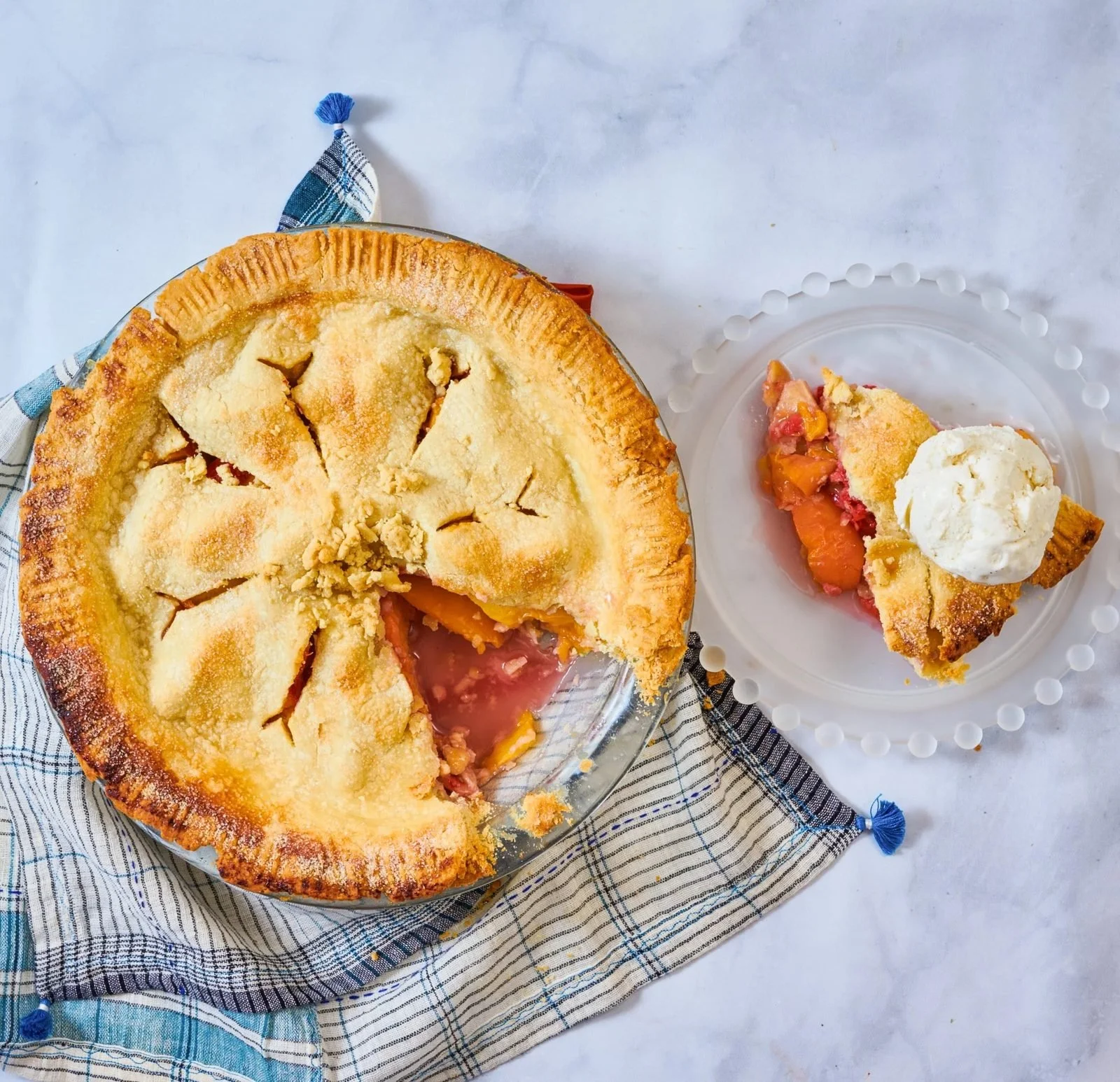 Food styling: fruit pie with a slice and ice cream