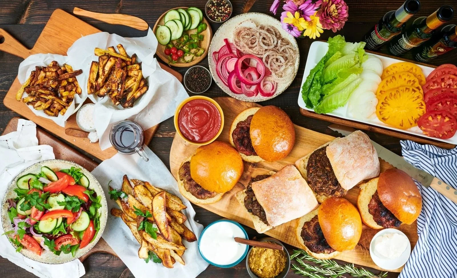 Edible East Bay burger dinner spread with toppings, editorial food photography