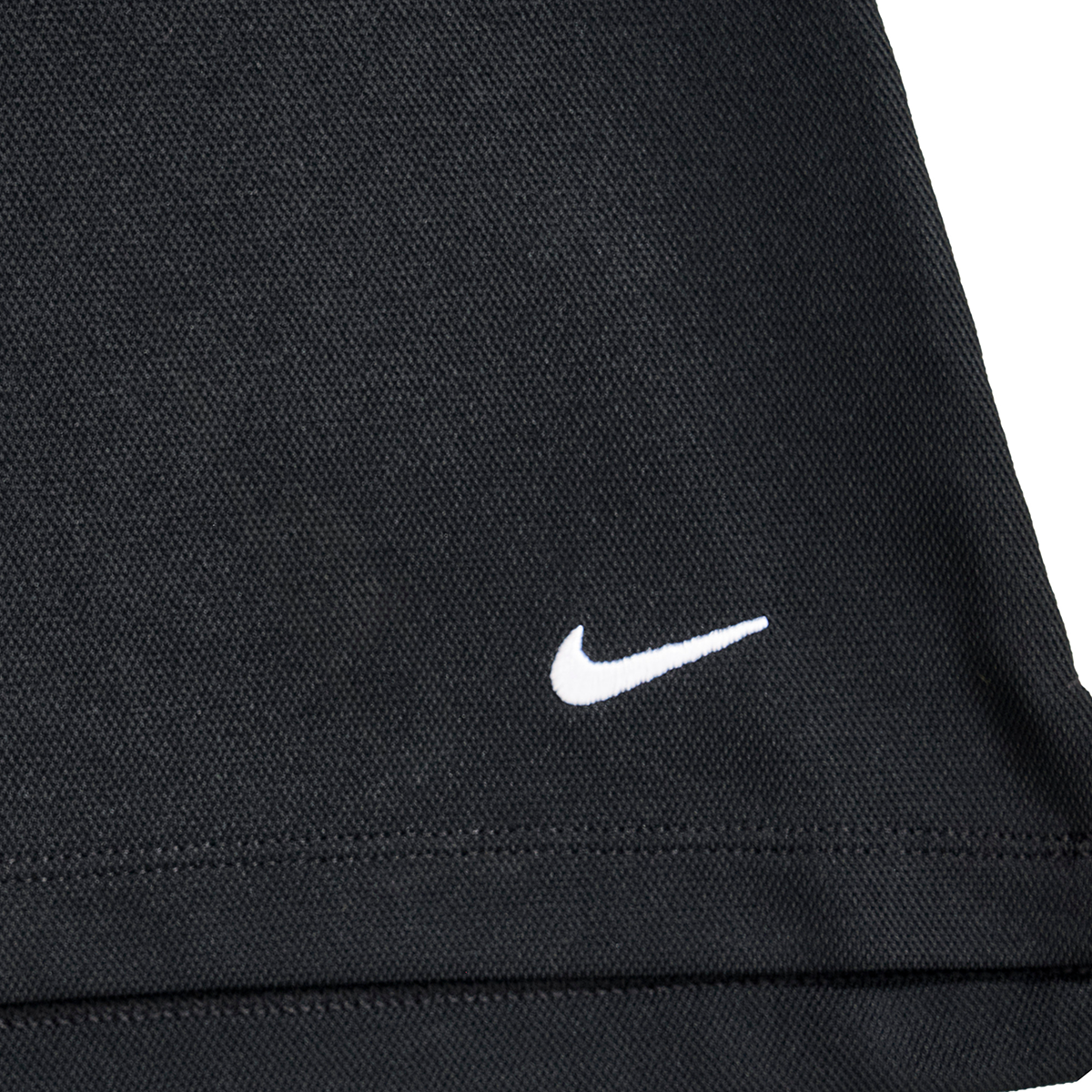 Close-up of a black Nike sports bag with a white embroidered swoosh logo.