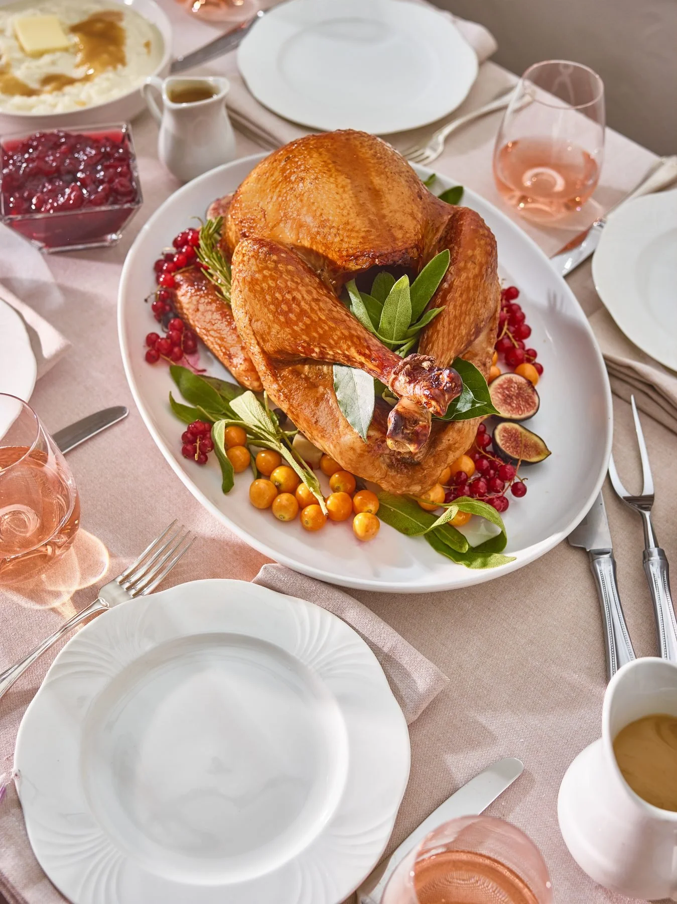 Roast Thanksgiving turkey on a set holiday table. Holiday food photography for grocery, meat and recipe content.