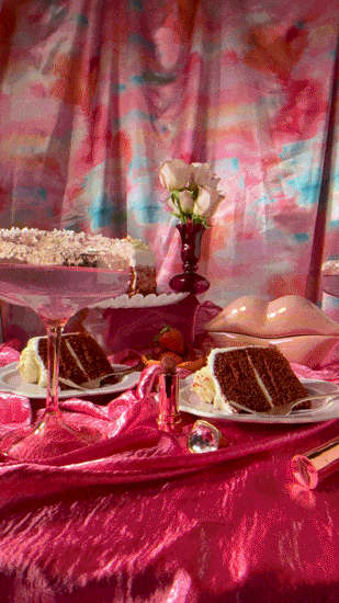 Layer cake and strawberries on a pink party table, food stop motion