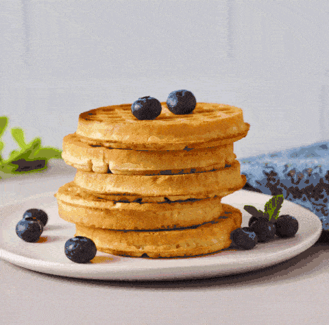 Stop motion GIF of maple syrup drizzling over a pancake stack. Animated breakfast content.
