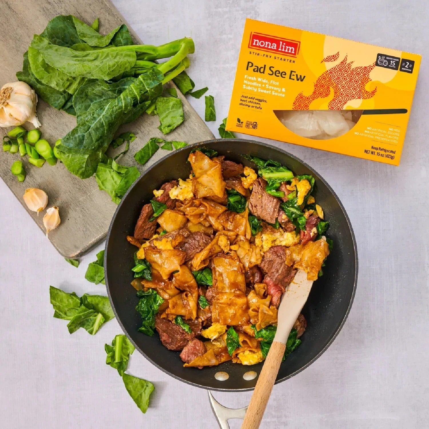 Nona Lim Pad See Ew noodles package with noodles in a wok, CPG food photography
