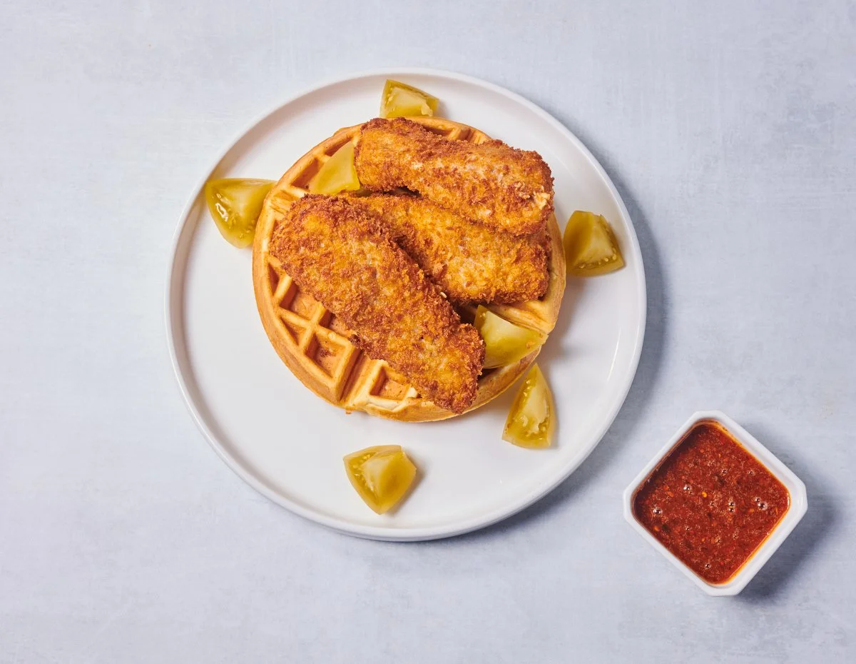 Waffle with crispy chicken tenders and red dipping sauce
