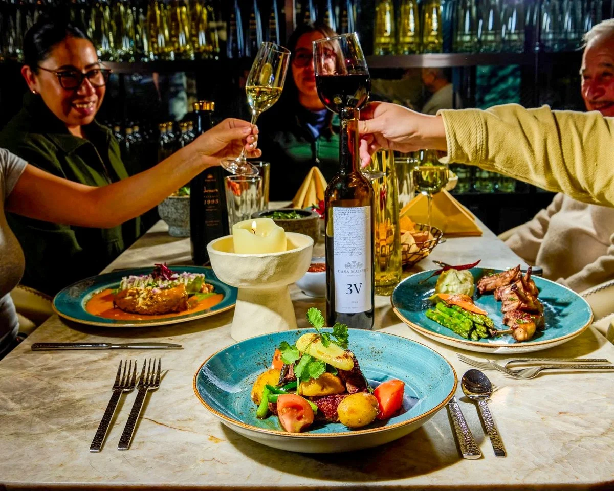 Friends toasting wine at a restaurant table