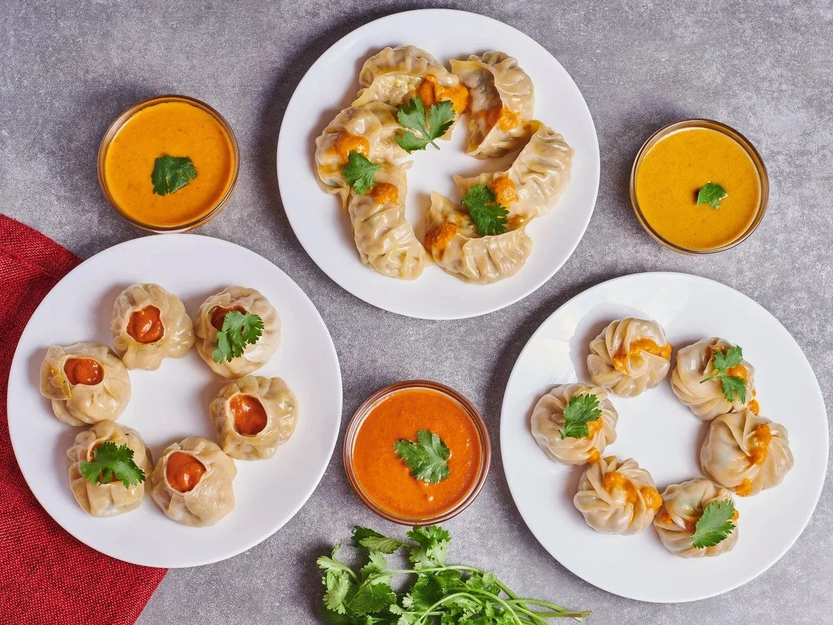 Momo dumplings arranged with dipping sauces