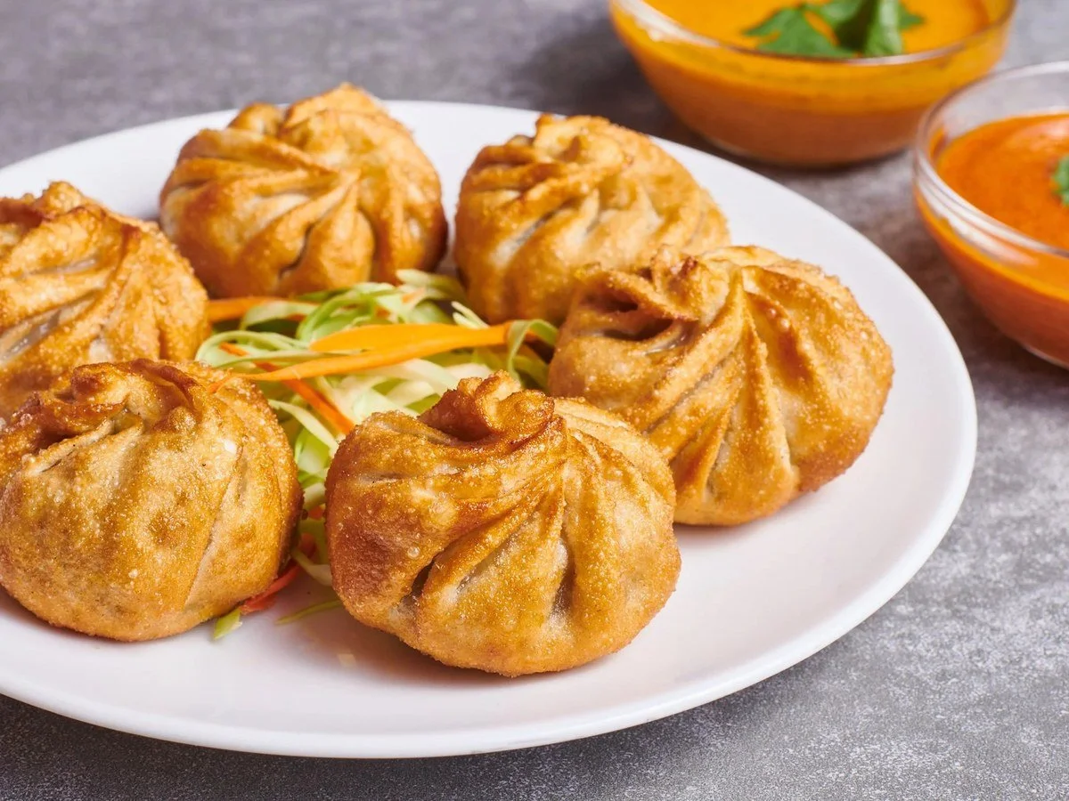 Fried momo dumplings with dipping sauce