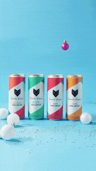 Sparkling cans with a floating ornament on blue motion GIF, holiday CPG beverage video