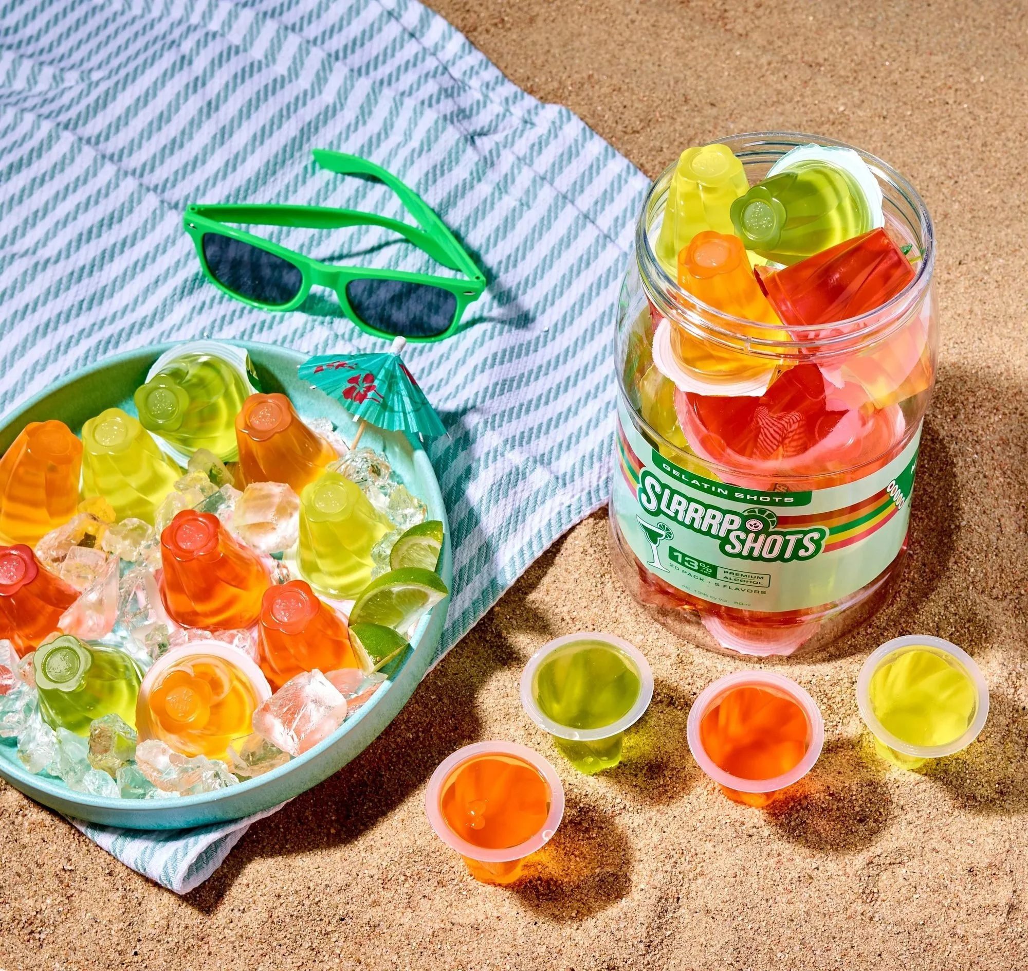 SLRRRP jelly snacks with sunglasses on a beach blanket, summer CPG snack photography