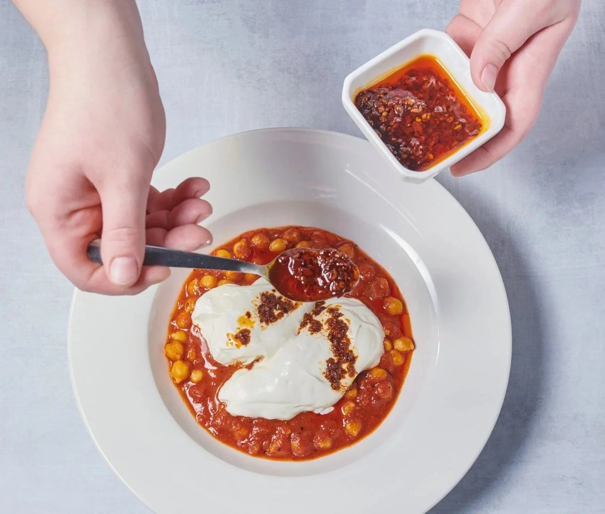 Chili crisp spooned over chickpeas and yogurt