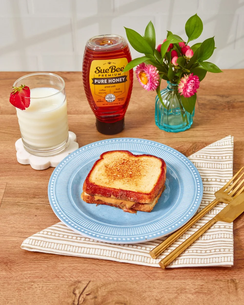 Grilled cheese sandwich drizzled with Sue Bee honey with milk. Comfort food recipe photography for a honey brand.