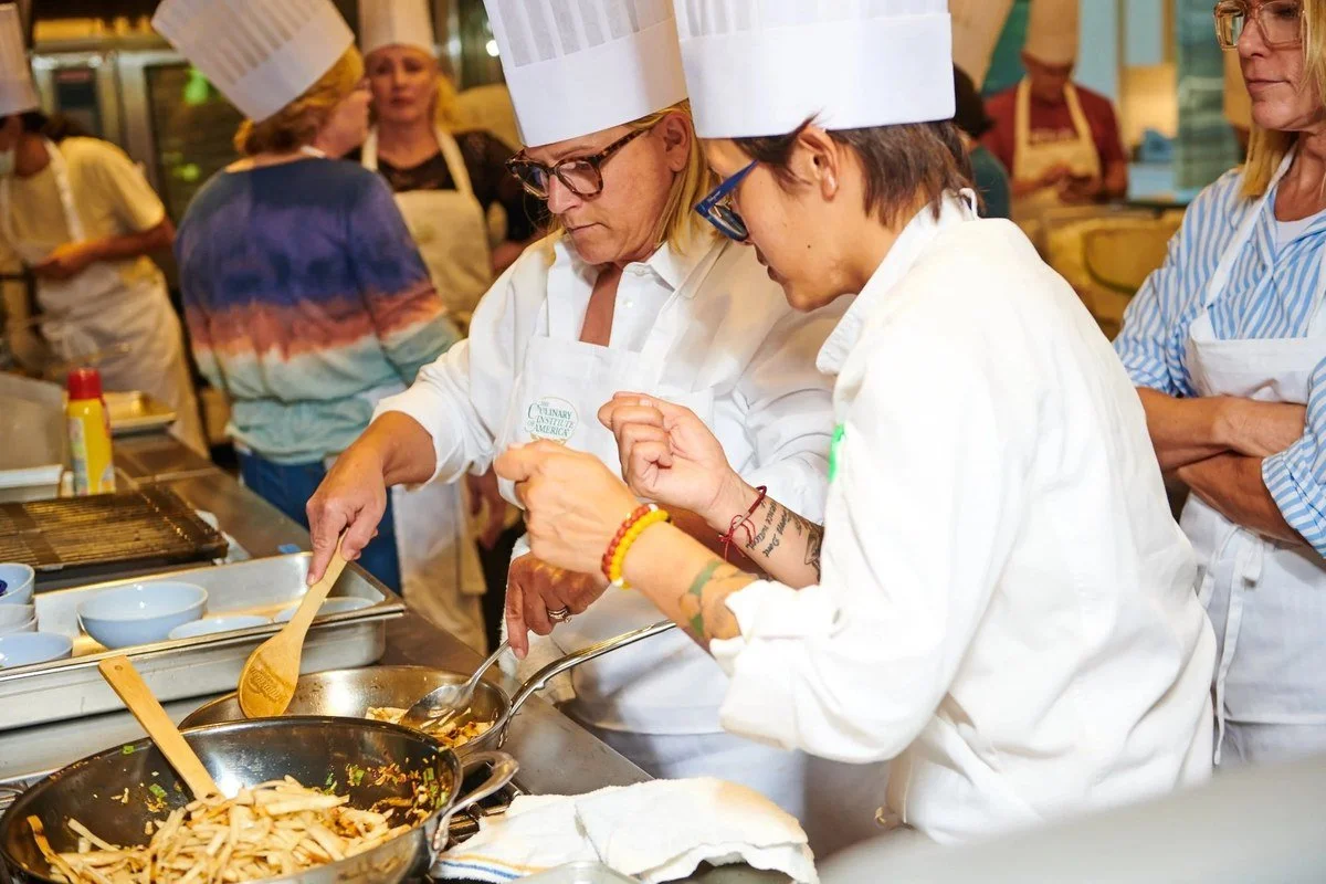 Chefs in whites at a cooking class