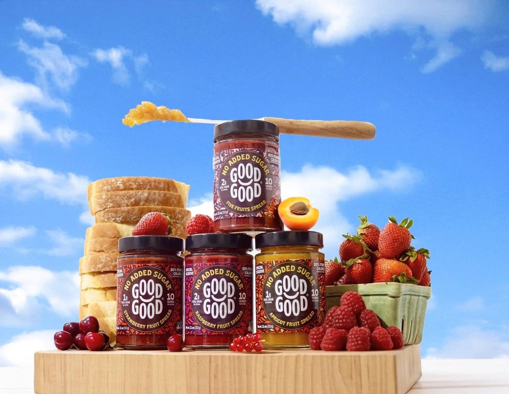 Good Good no sugar added jam jars stacked against a blue sky, creative CPG photography