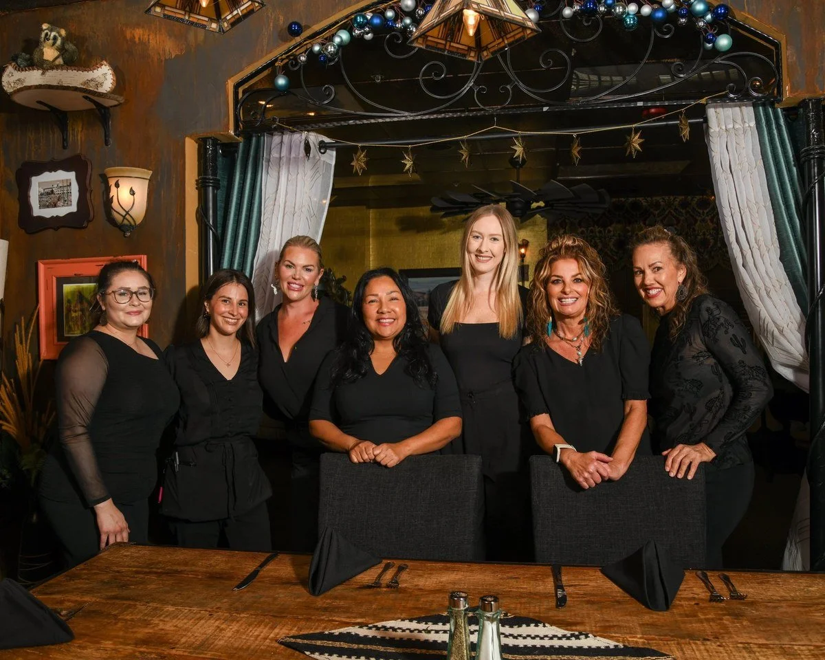 Restaurant team group portrait in a Western-style dining room