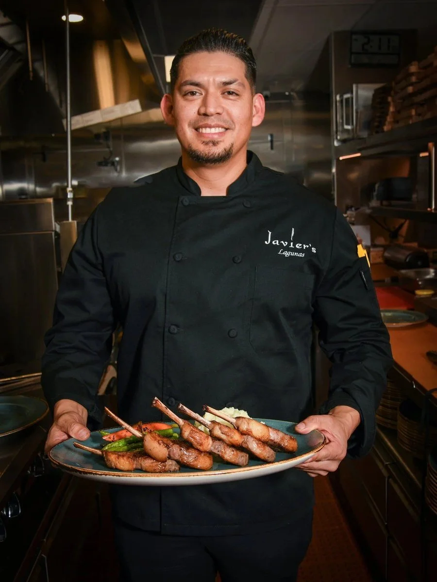 Chef portrait holding a plate of skewers