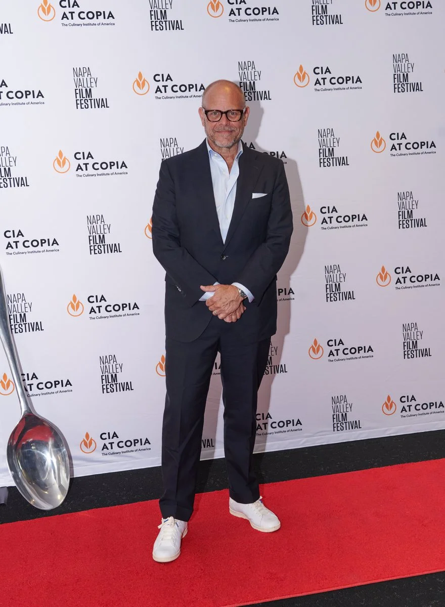 Chef on the red carpet at a Culinary Institute of America at Copia event in Napa with with celebrity photos