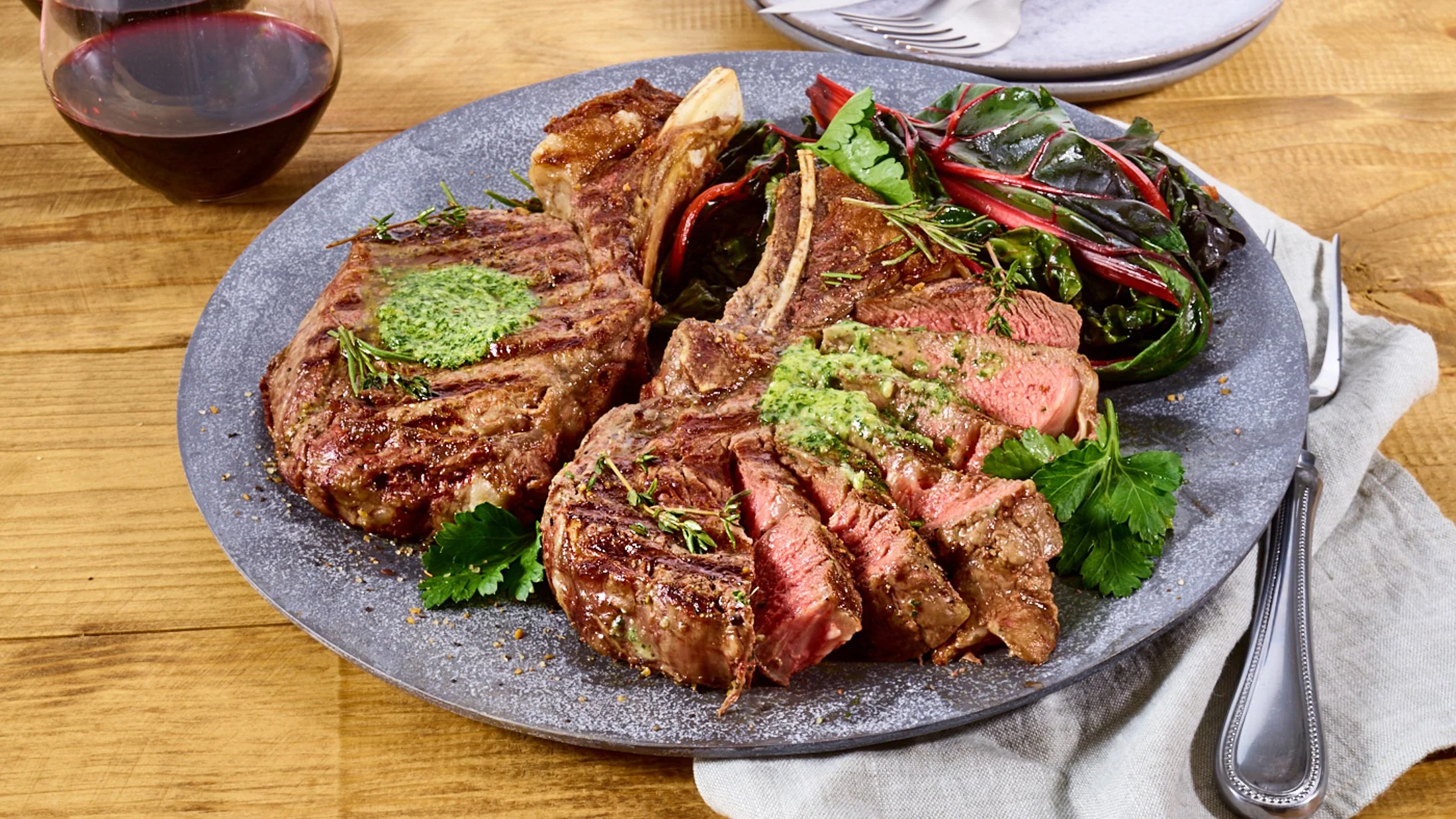 Food styling: grilled bone-in ribeye steaks with herb butter