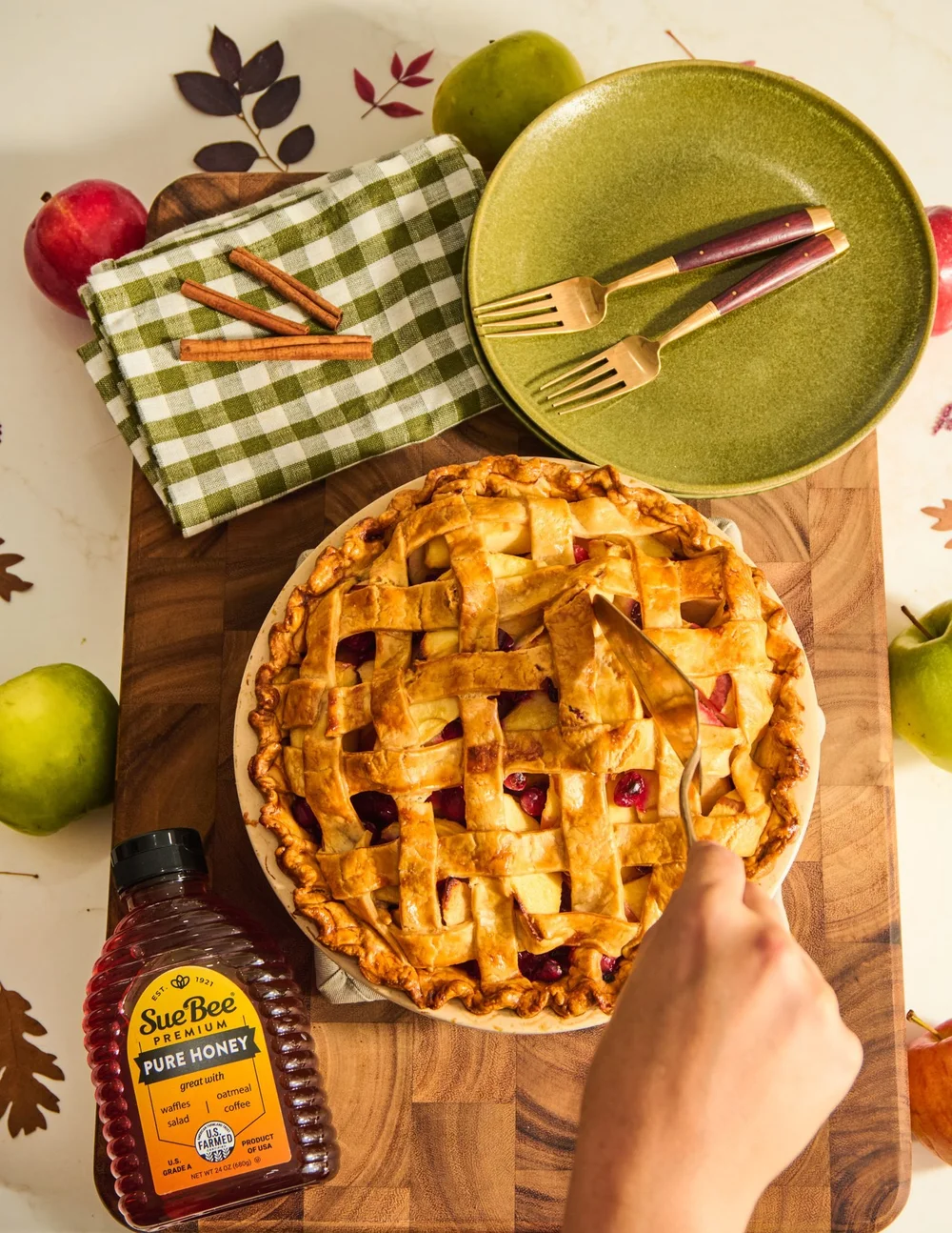 Apple pie with Sue Bee honey on a fall table. Seasonal fall recipe photography for a honey brand.