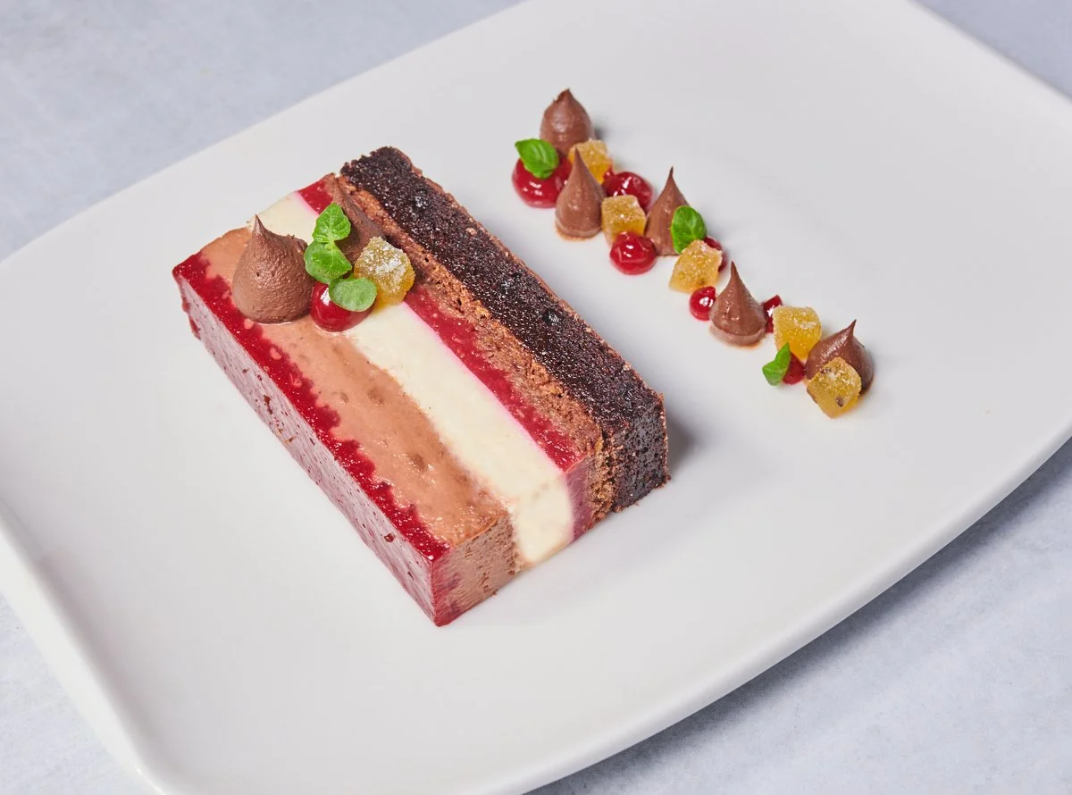 Plated layered chocolate and berry dessert from the Culinary Institute of America restaurant menu