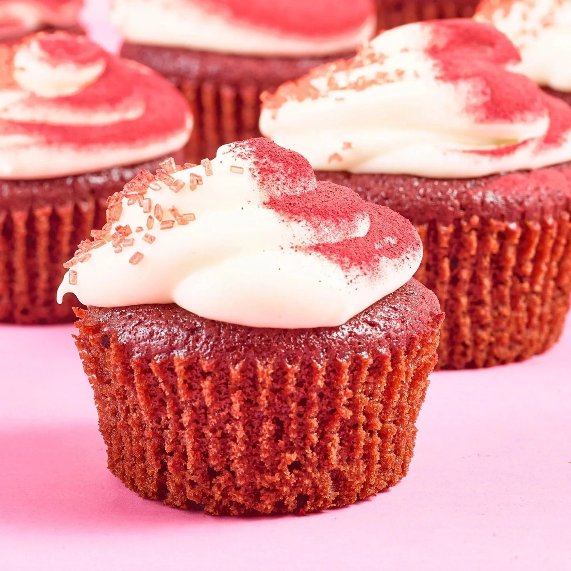 Red velvet cupcakes with cream cheese frosting, close up. Bakery and dessert food photography.