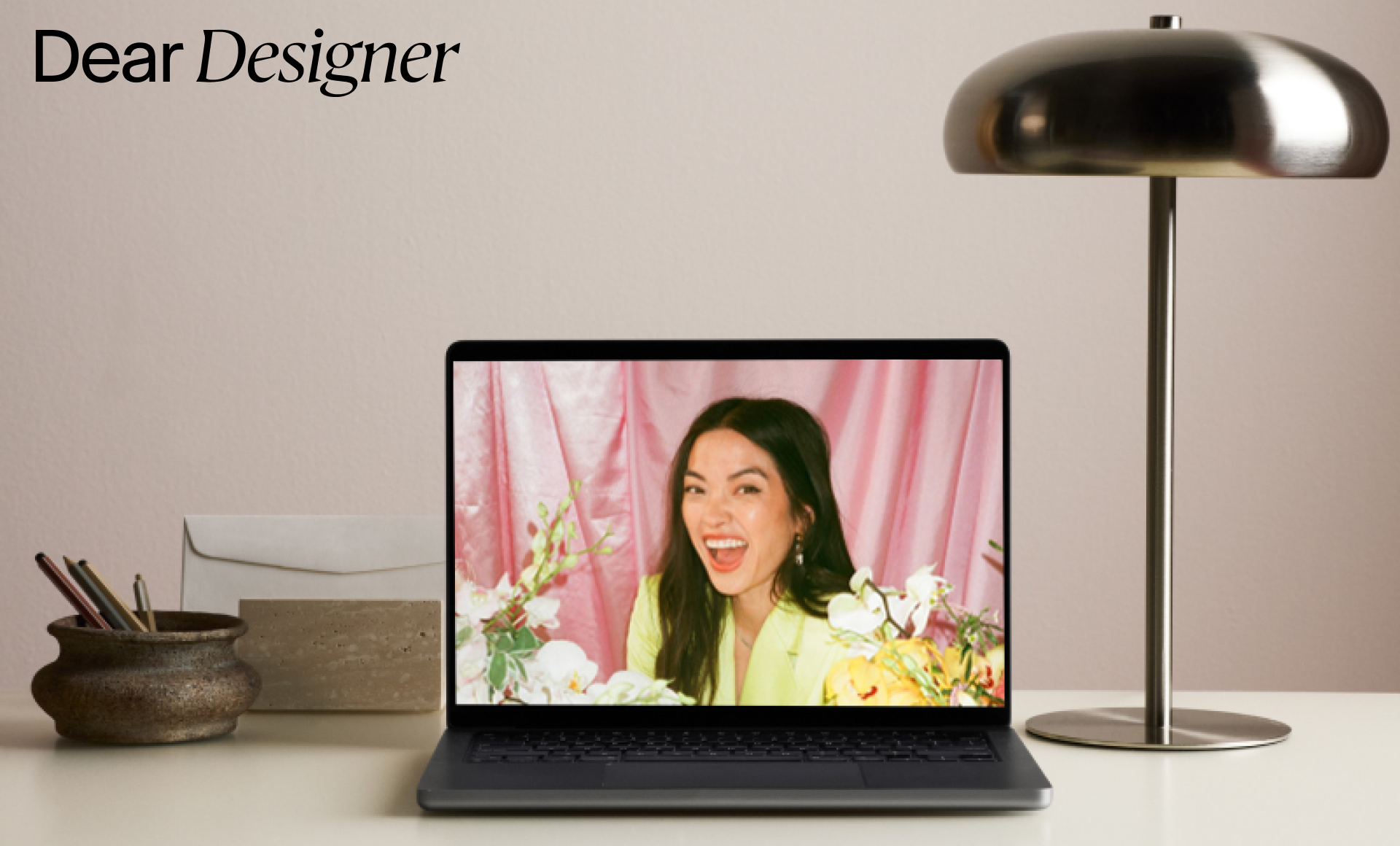 Laptop with Puno's headshot and "Dear Designer" in the top left corner