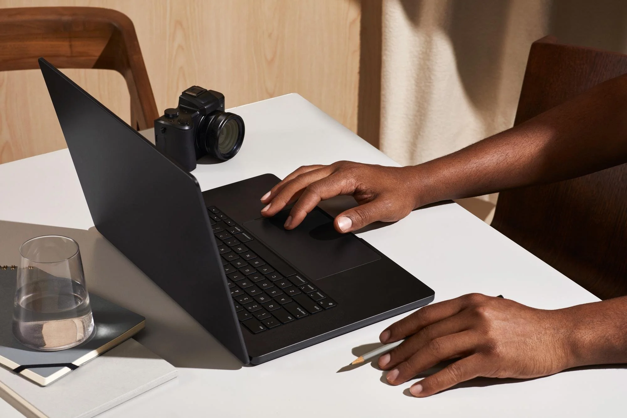 A web designer scrolling on a laptop