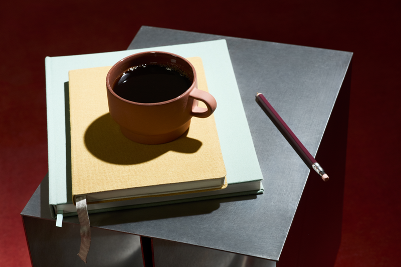A coffee mug on top of two stacked books