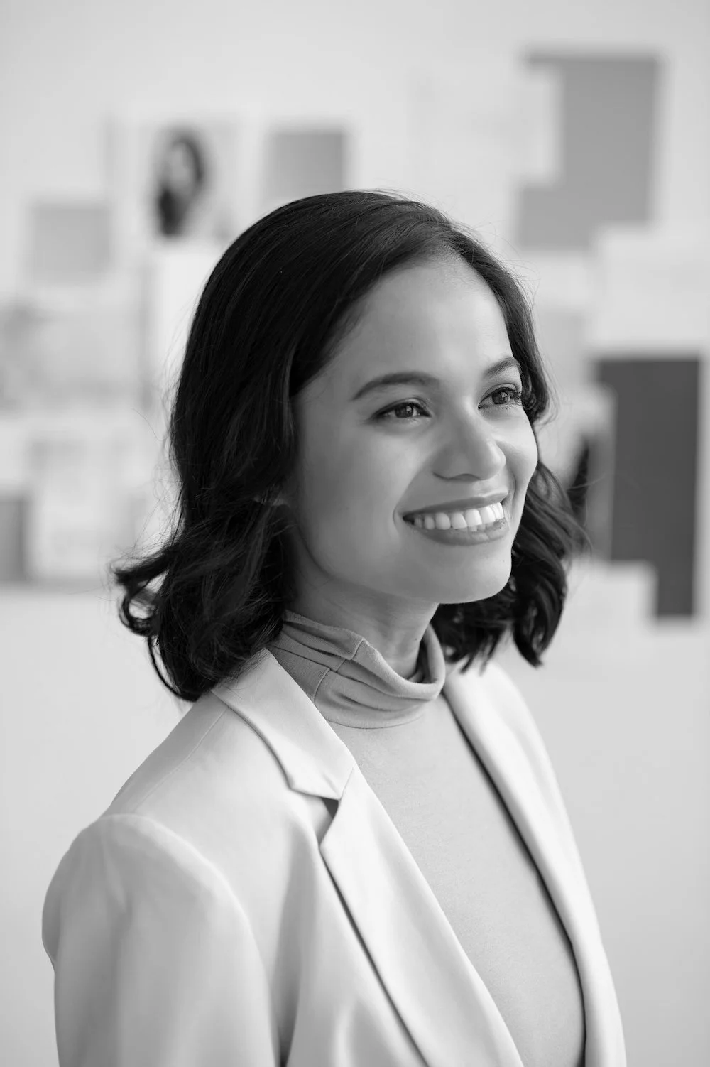 A black-and-white headshot of Rache De Luna