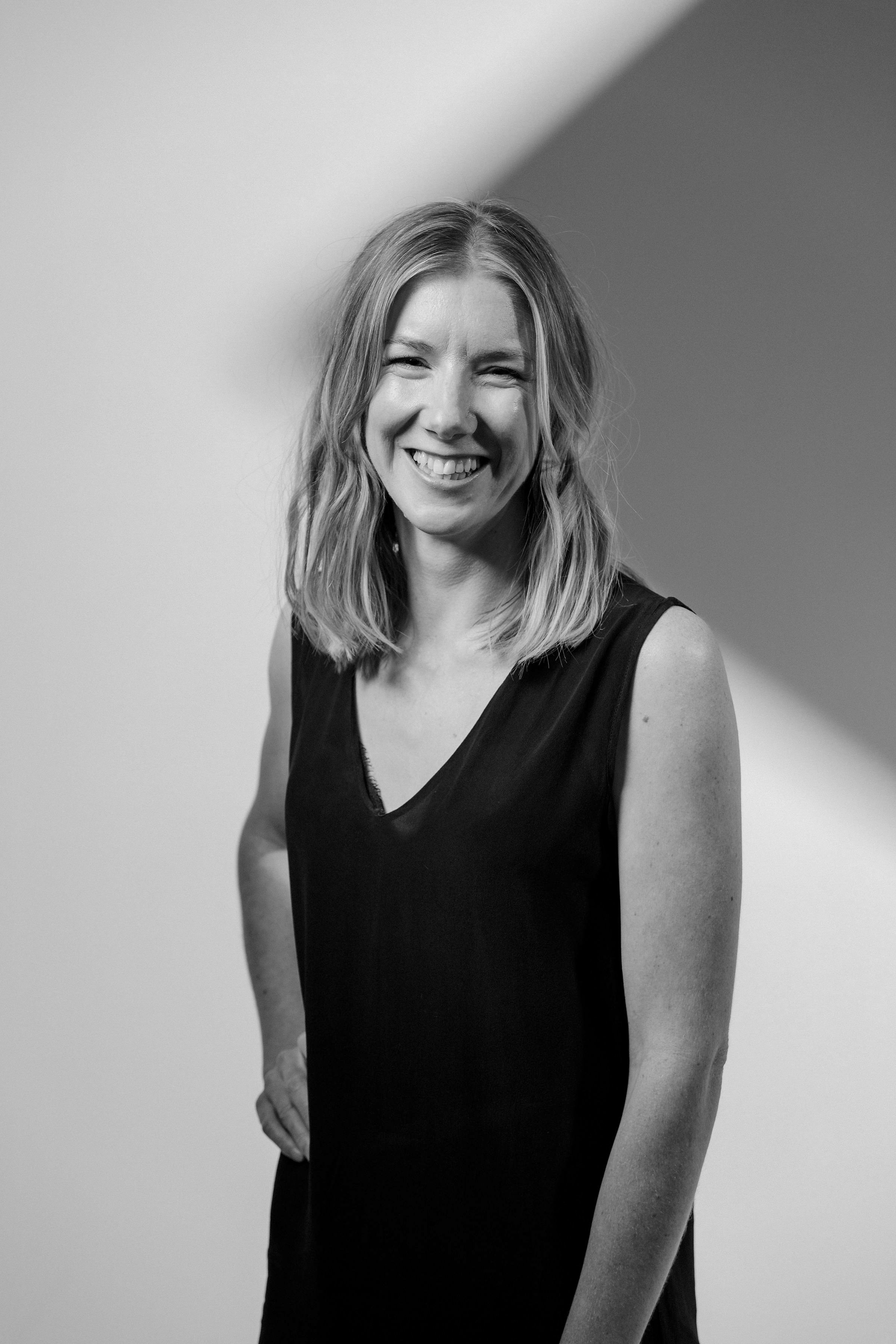 A black-and-white image of Hannah Ippolito smiling at the camera