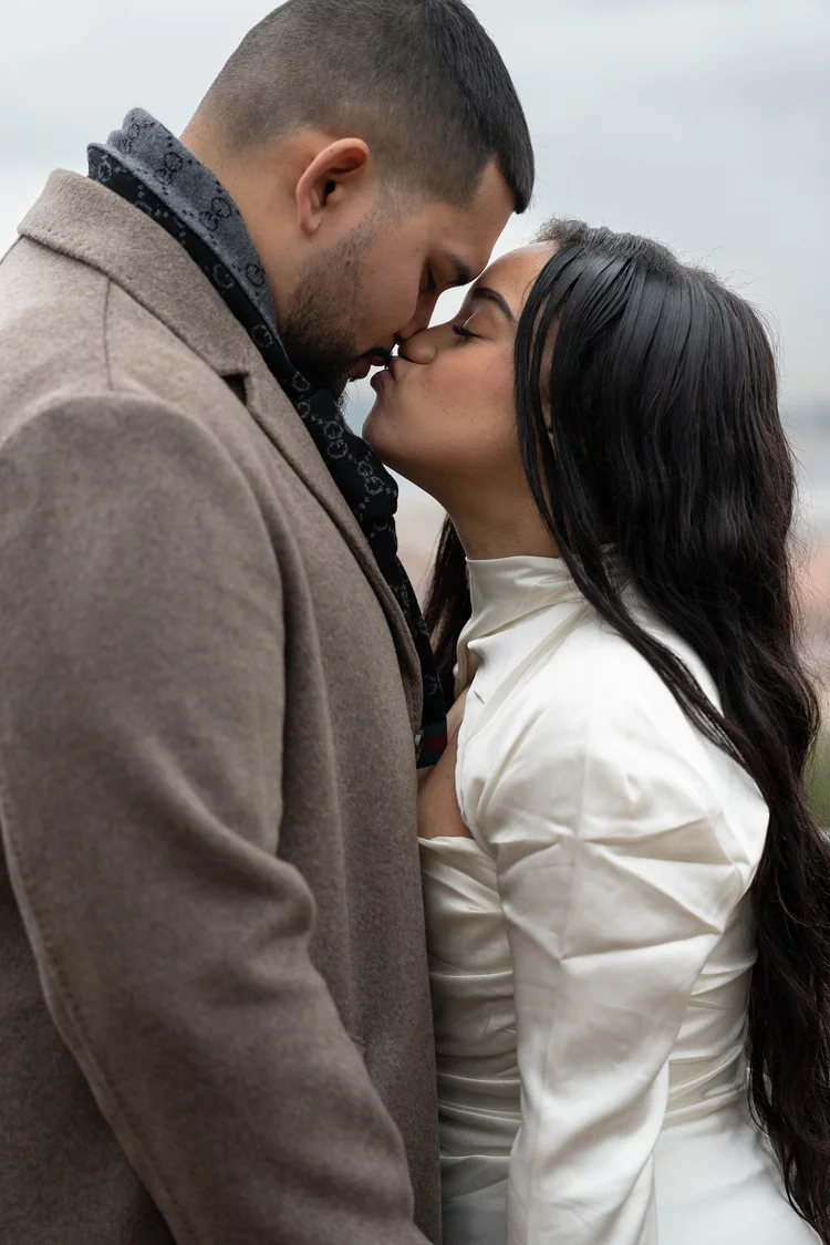 Couple in winter coats kissing during a Rome photoshoot by Love Society Studios
