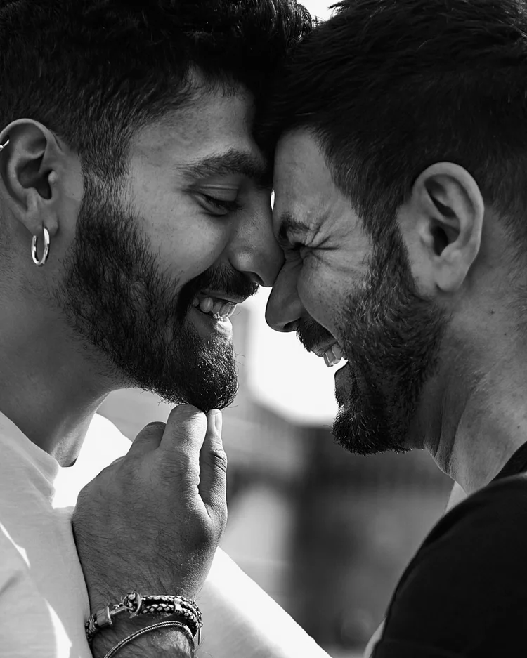 Two men laughing forehead to forehead during a couples photoshoot in Rome