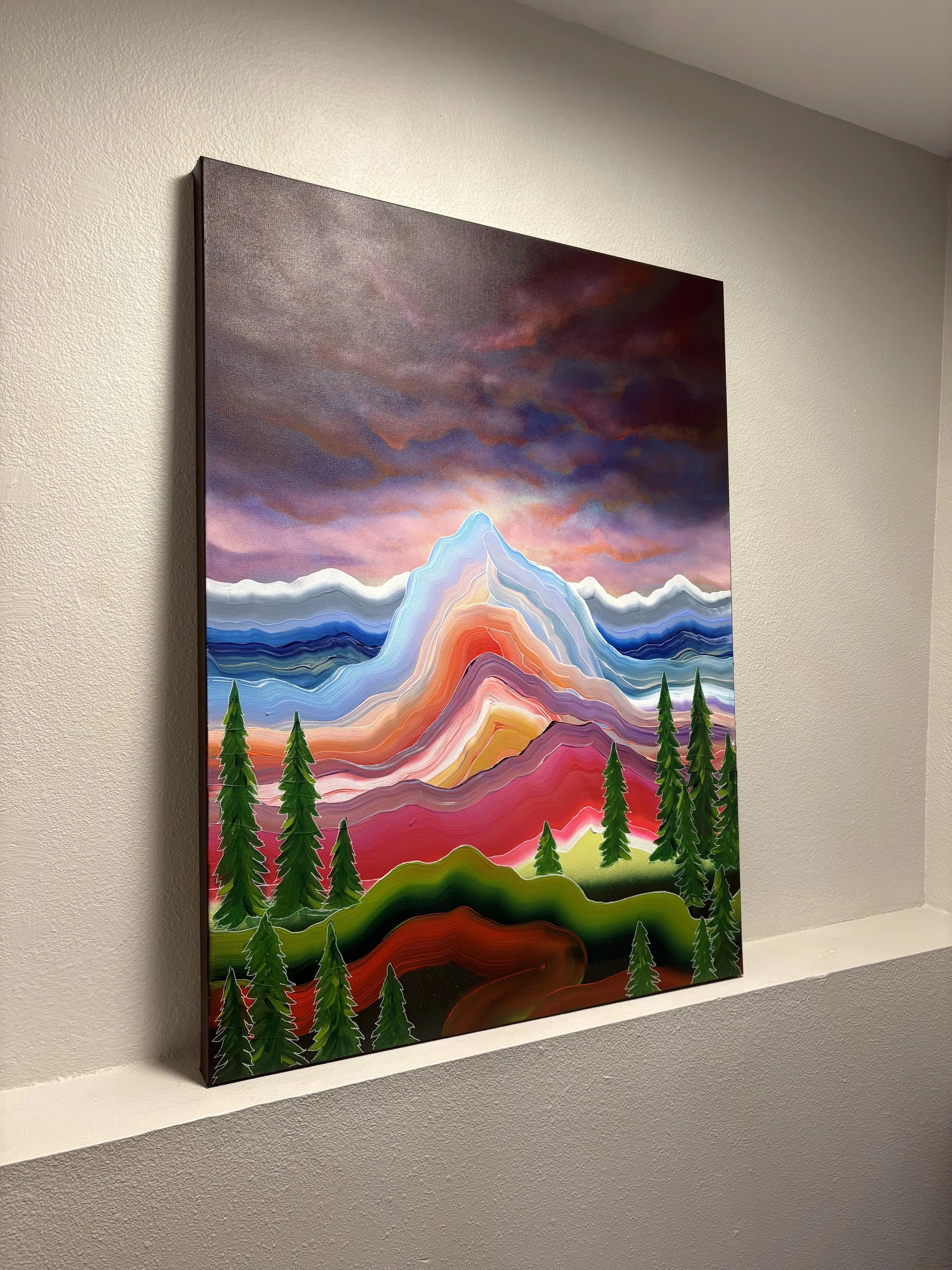 Even Under Dark Skies painting by Colorado artist Jessie Belisle — vibrant layered mountain landscape beneath a dark dramatic sky with evergreen trees.