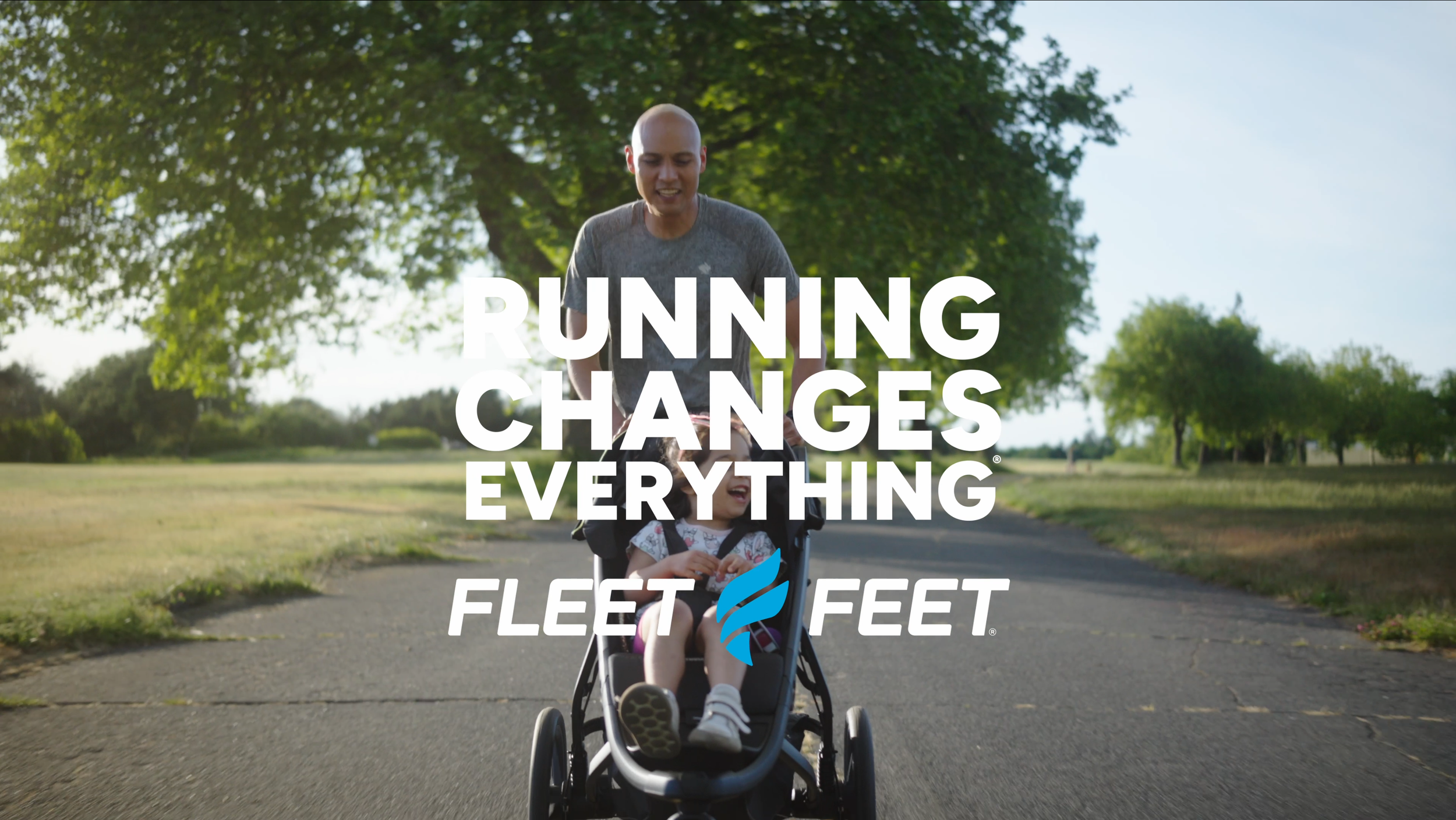 A man riunning with a child in a stroller on a park path, trees and green grass in the background, with the text 'Running Changes Everything' and a Fleet Feet logo.
