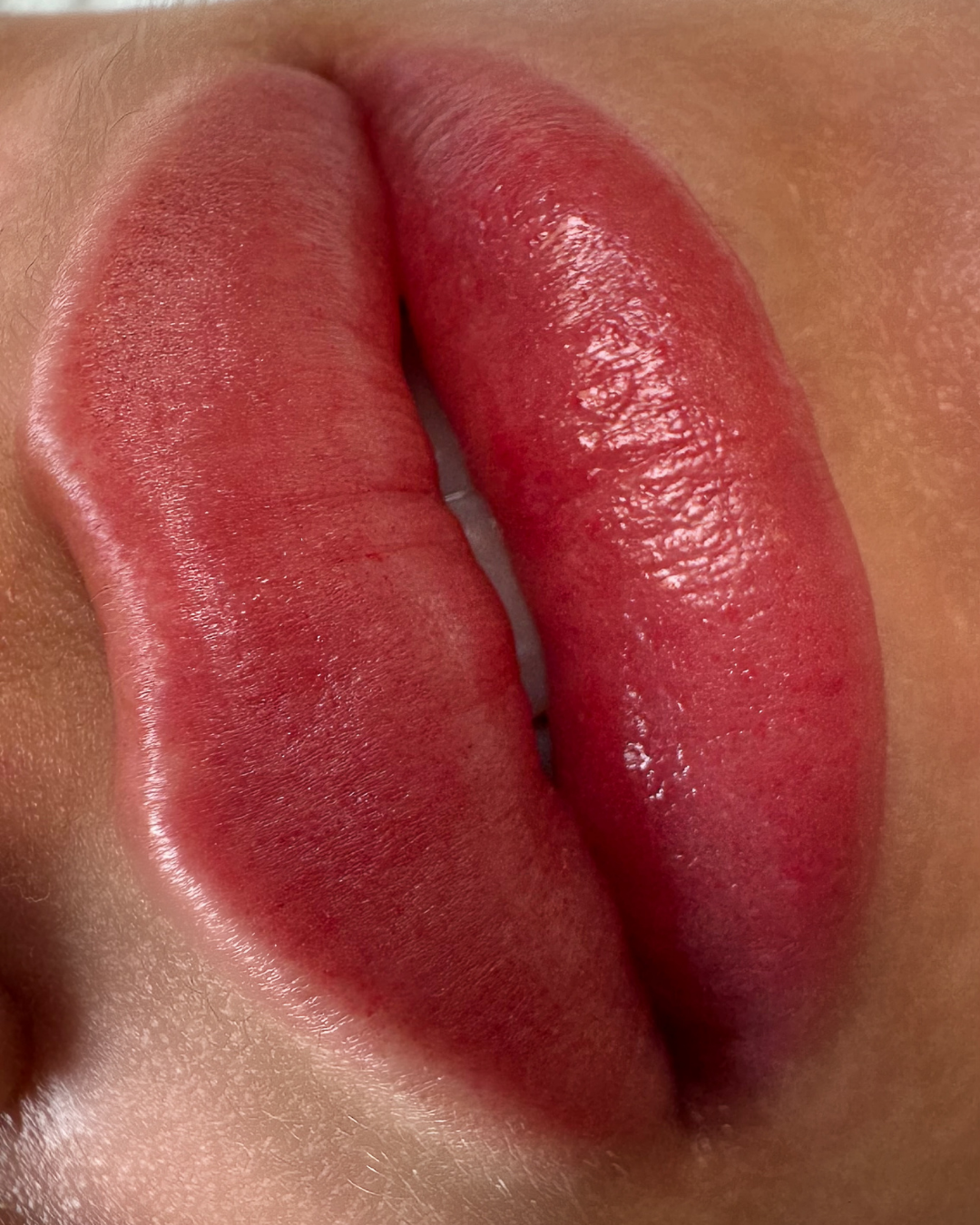 Close-up of red, glossy lips.