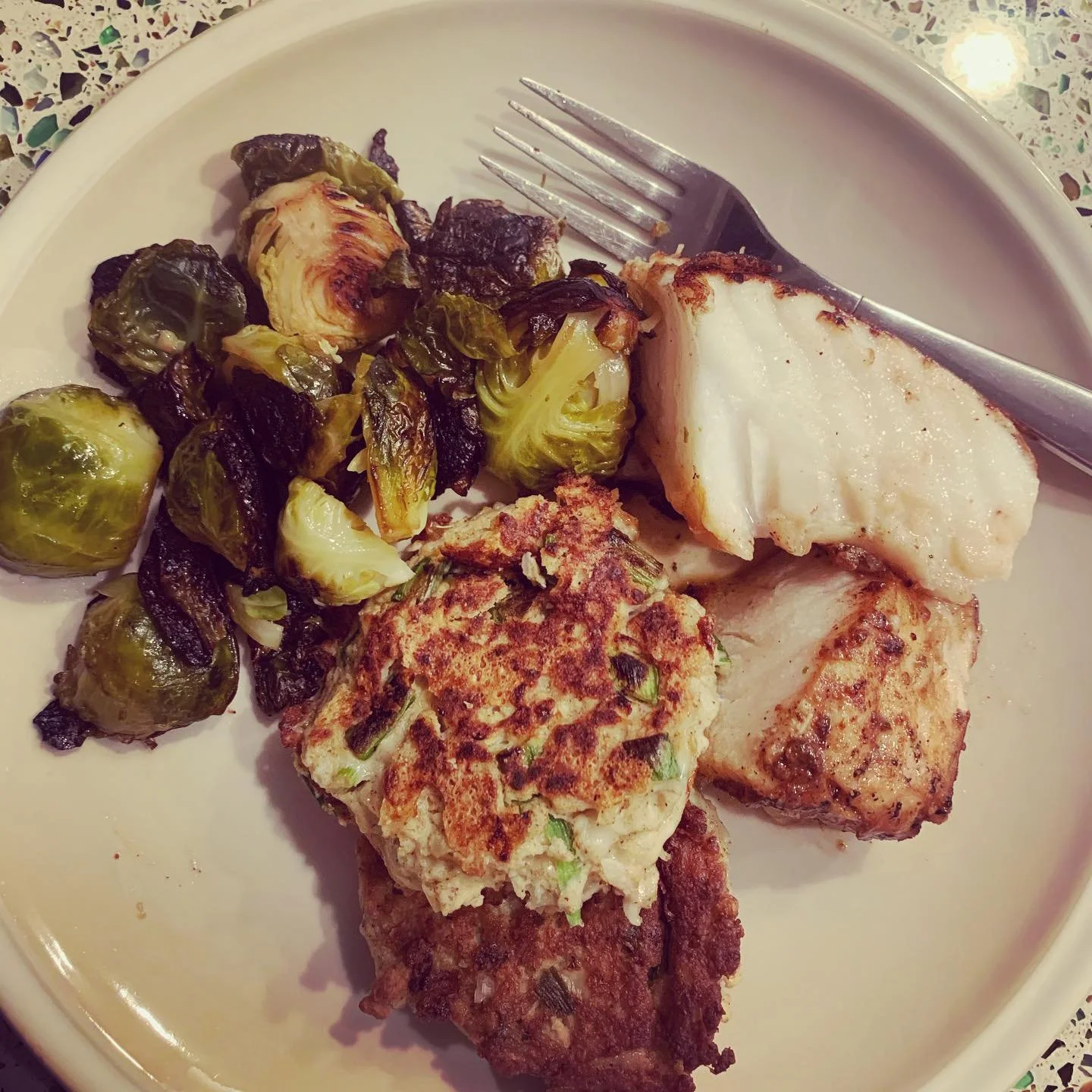 Cauliflower latkes, burnt Brussels and pan seared seabass.  One of my most favorite quarantine meals enjoyed with great company @feeling.fein. Latke recipe adapted from @laurenpincusrd https://nutritionstarringyou.com/ &mdash;
I subbed the mozzarella