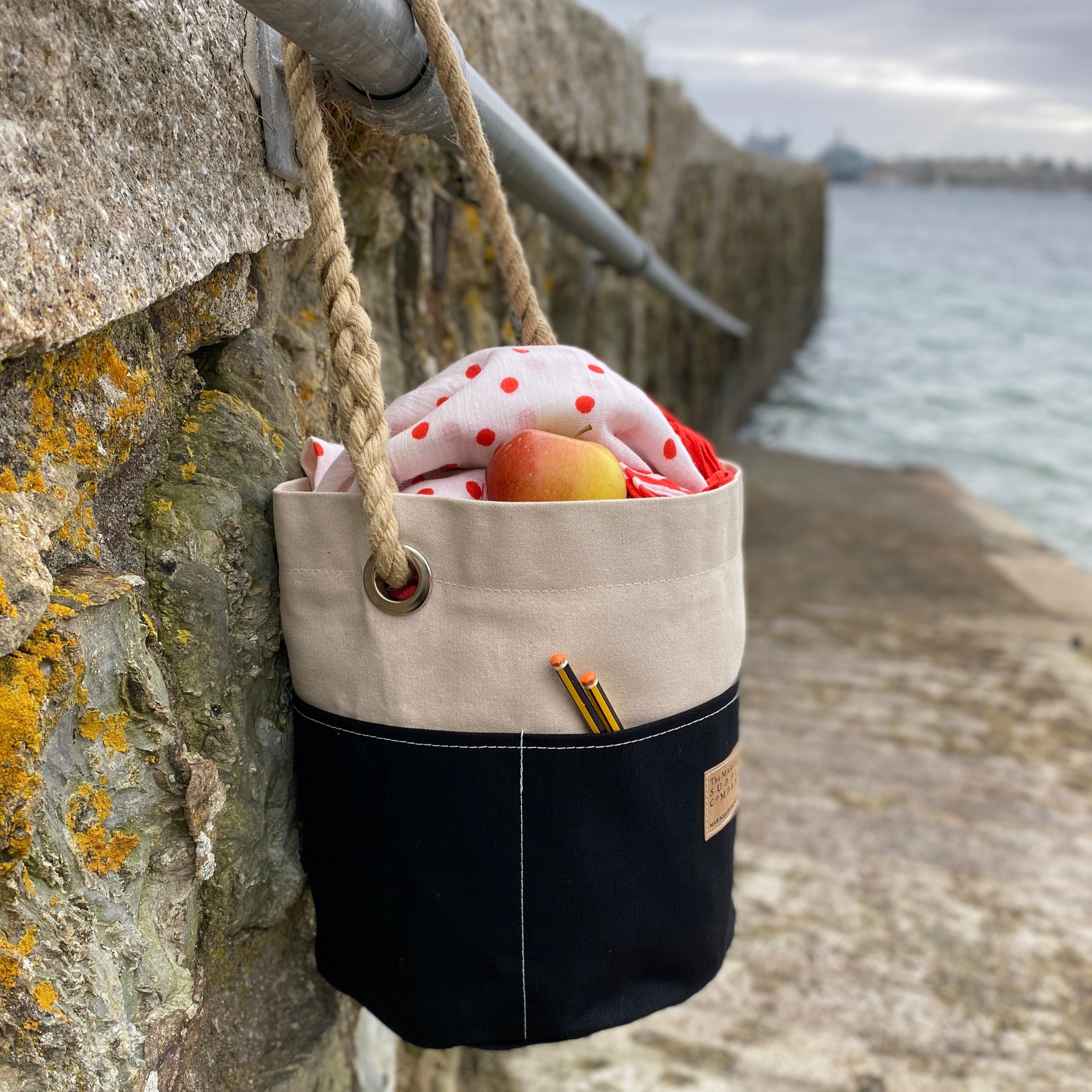 Nautical ditty bag in black and cream traditional canvas with rope handle.