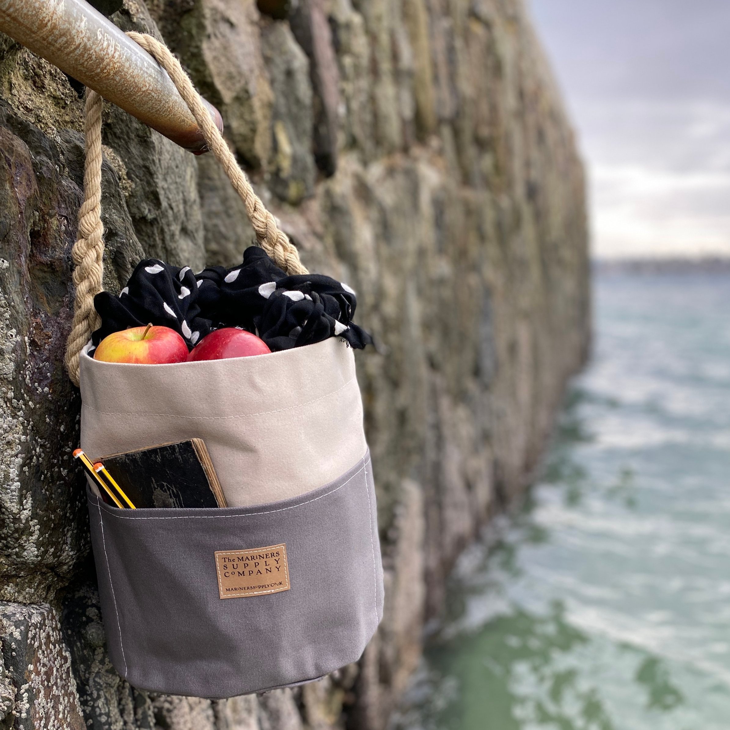 Nautical ditty bag in grey and cream traditional canvas with rope handle.