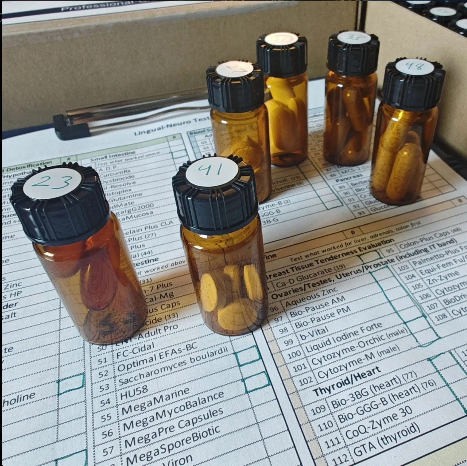 Glass drams filled with supplements for lingual-neuro testing