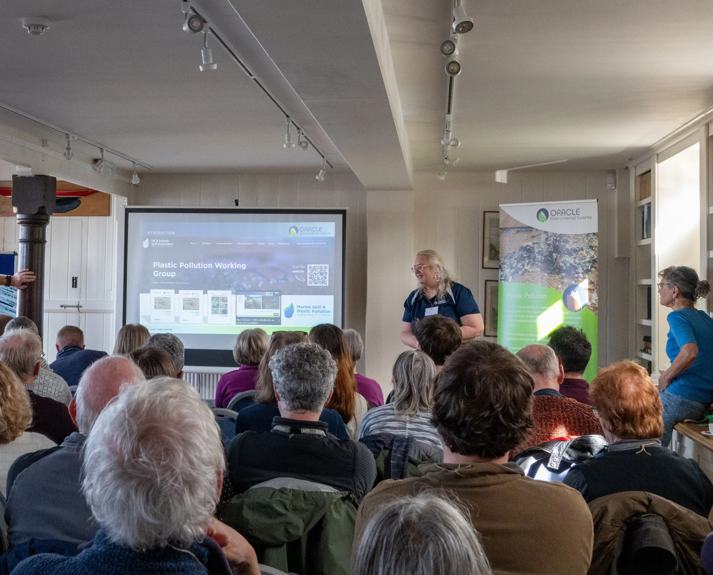 OEE staff member delivering a talk in front of community members in Isle of Wight.