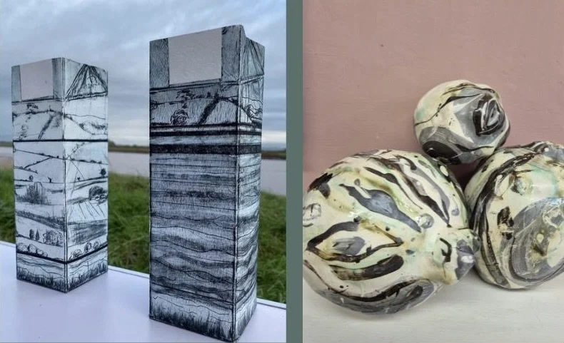 Artistic sculptures of soap bars and rounded objects that resemble stones, featuring abstract black and white patterns.