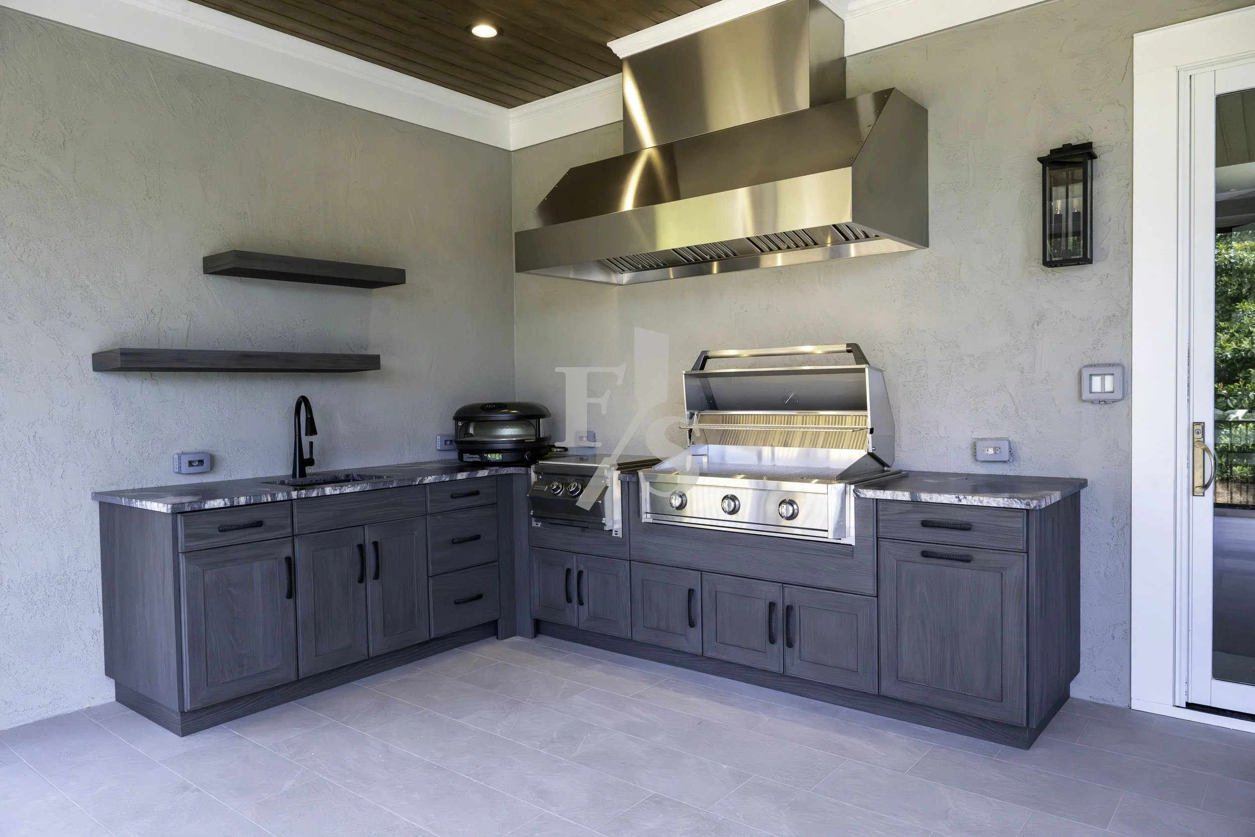 Naturekast with Gozney pizza Firemagic Power Burner and AOG grill with Tradewinds Hood and floating shelves. 