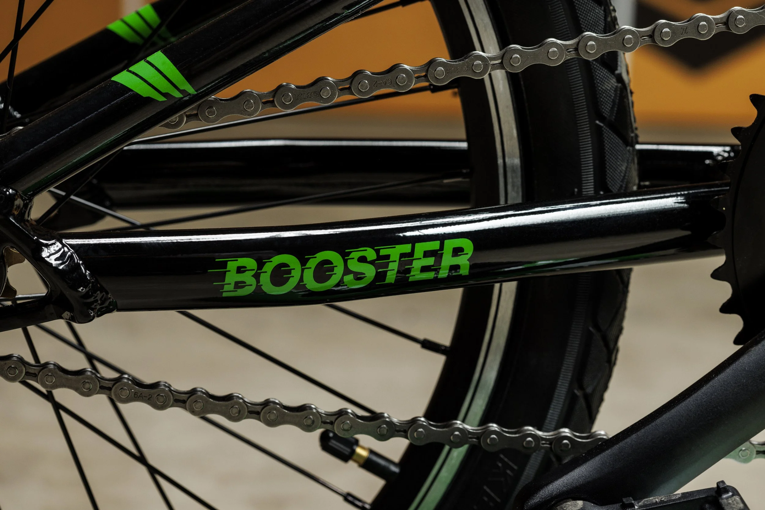 Achterwiel en ketting van de Booster met Booster-logo