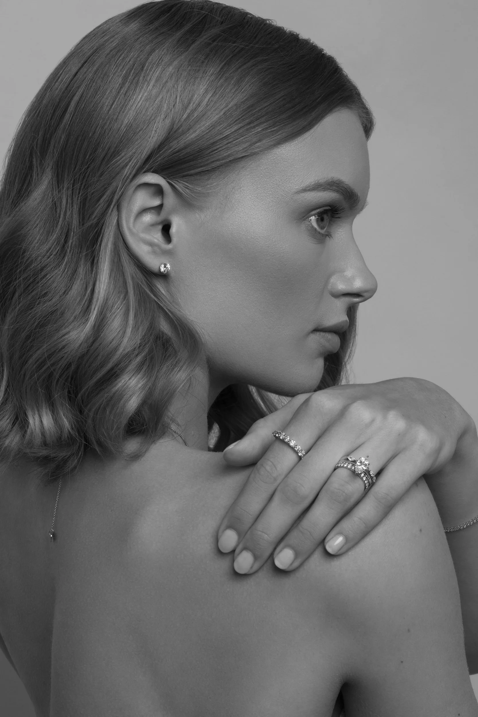Photograph of blonde model Devojka wearing Unique Diamonds earrings, ring and necklace by Canberra photographer Tina Nikolovski