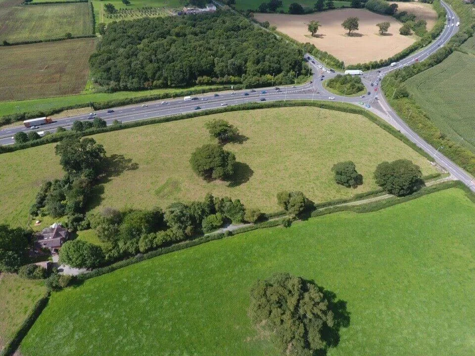 Drone shot of a field and a roundabout