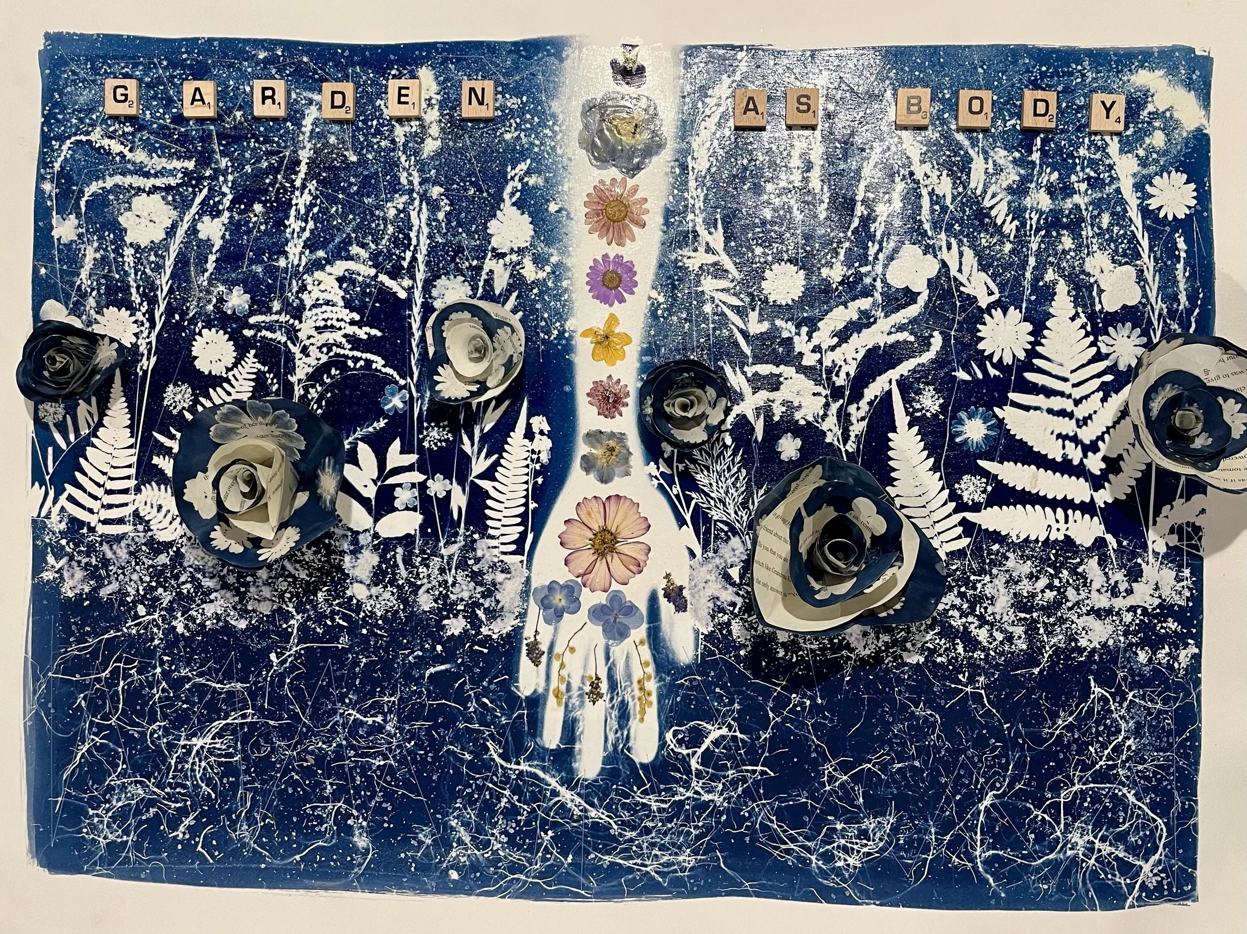 "Garden As Body" Mixed Media Cyanotype with glow-in-the-dark thread and glitter, paper flowers, creative writing