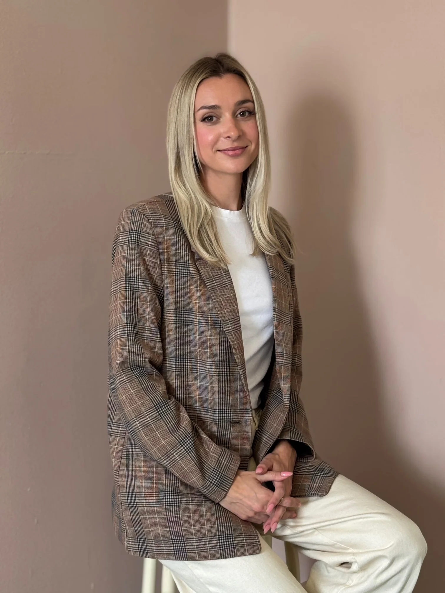 Blonde woman on chair, smiling